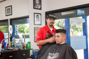 Photo of Mark Saavedra cutting hair