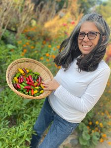 photo of Pamela Marquez holding a basket of chilies