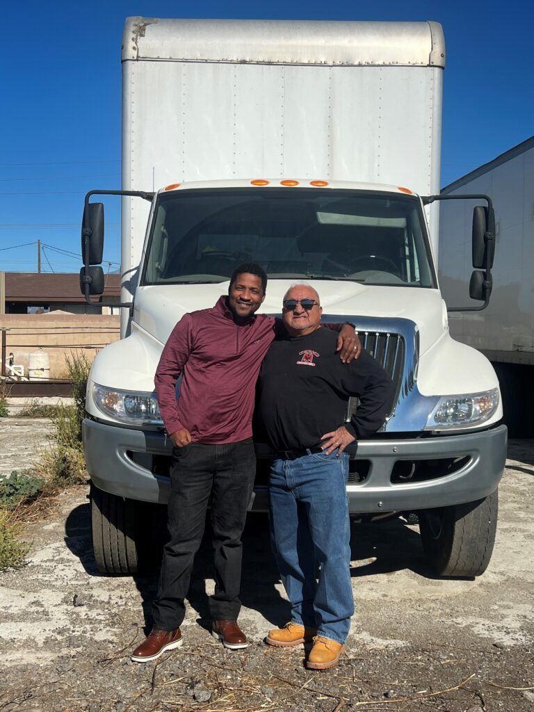 Jay Diallo, President and CEO of First Community Capital, with one of their small business clients.