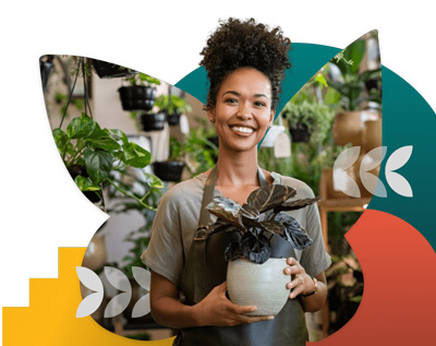 A woman at a plant shop holds a plant and smiles, with colorful abstract shapes behind her